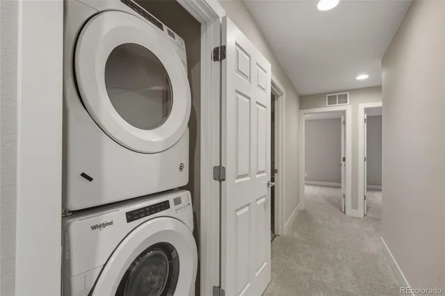 a bedroom with a bed and a dresser next to a window