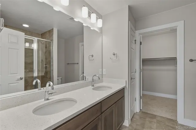 a bathroom with a granite countertop sink a mirror and a bathtub