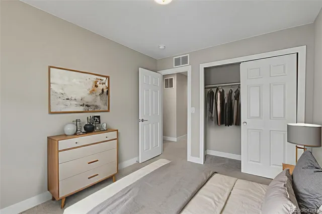 a bedroom with bed and a potted plant