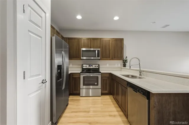 a kitchen with a sink stove and microwave