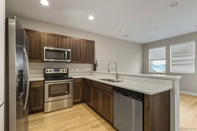 a kitchen with a refrigerator stove and sink