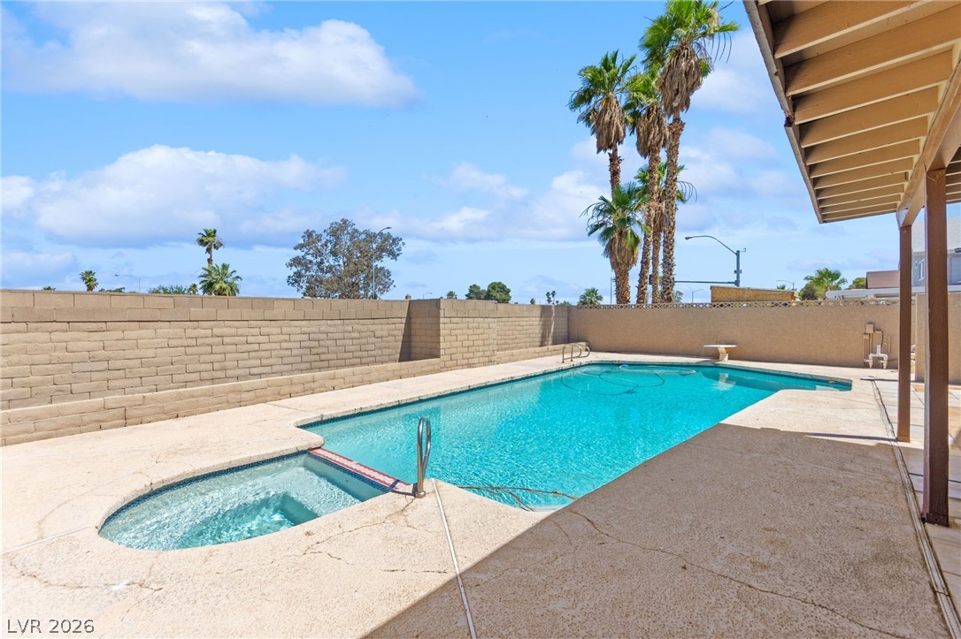 4430 Cranbrook Way Las Vegas, NV 89103 - Photo 4 of 50 An inviting backyard oasis offers a pristine inground pool perfect for relaxation and entertaining.