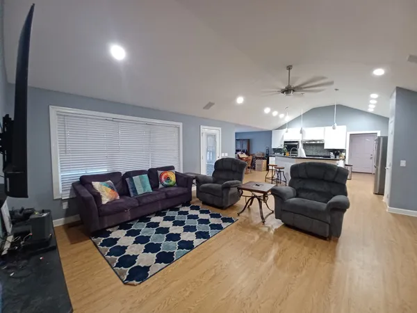 a living room with furniture a couch and a piano
