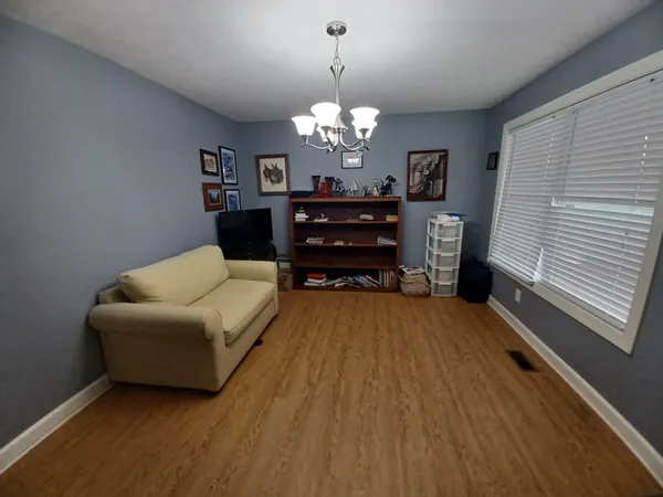 a living room with furniture and a chandelier