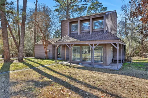 a front view of a house with a yard table and chairs