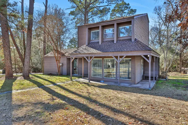 a front view of a house with a yard table and chairs