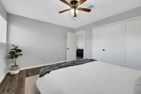 a bedroom with a bed and a potted plant