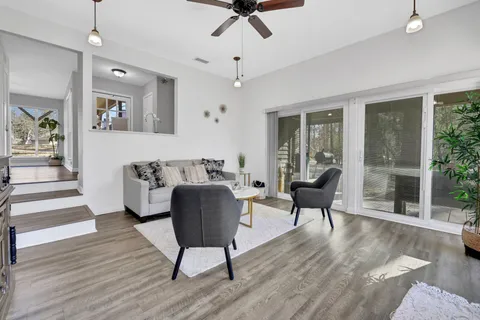 a living room with furniture and a wooden floor