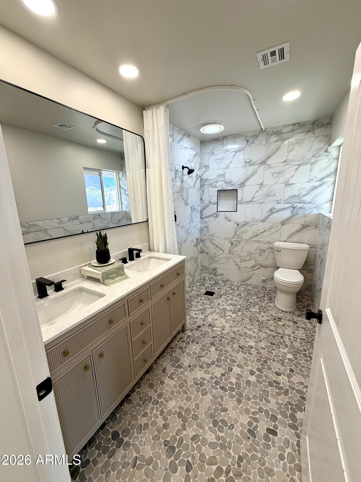 1165 North Mountain View Road Apache Junction, AZ 85119 - Photo 15 of 29 a bathroom with a sink a toilet and a shower