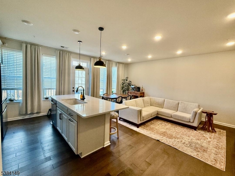 13 Sternadori Road Somerville, NJ 08876 - Photo 2 of 18 a living room with couches and kitchen view with wooden floor