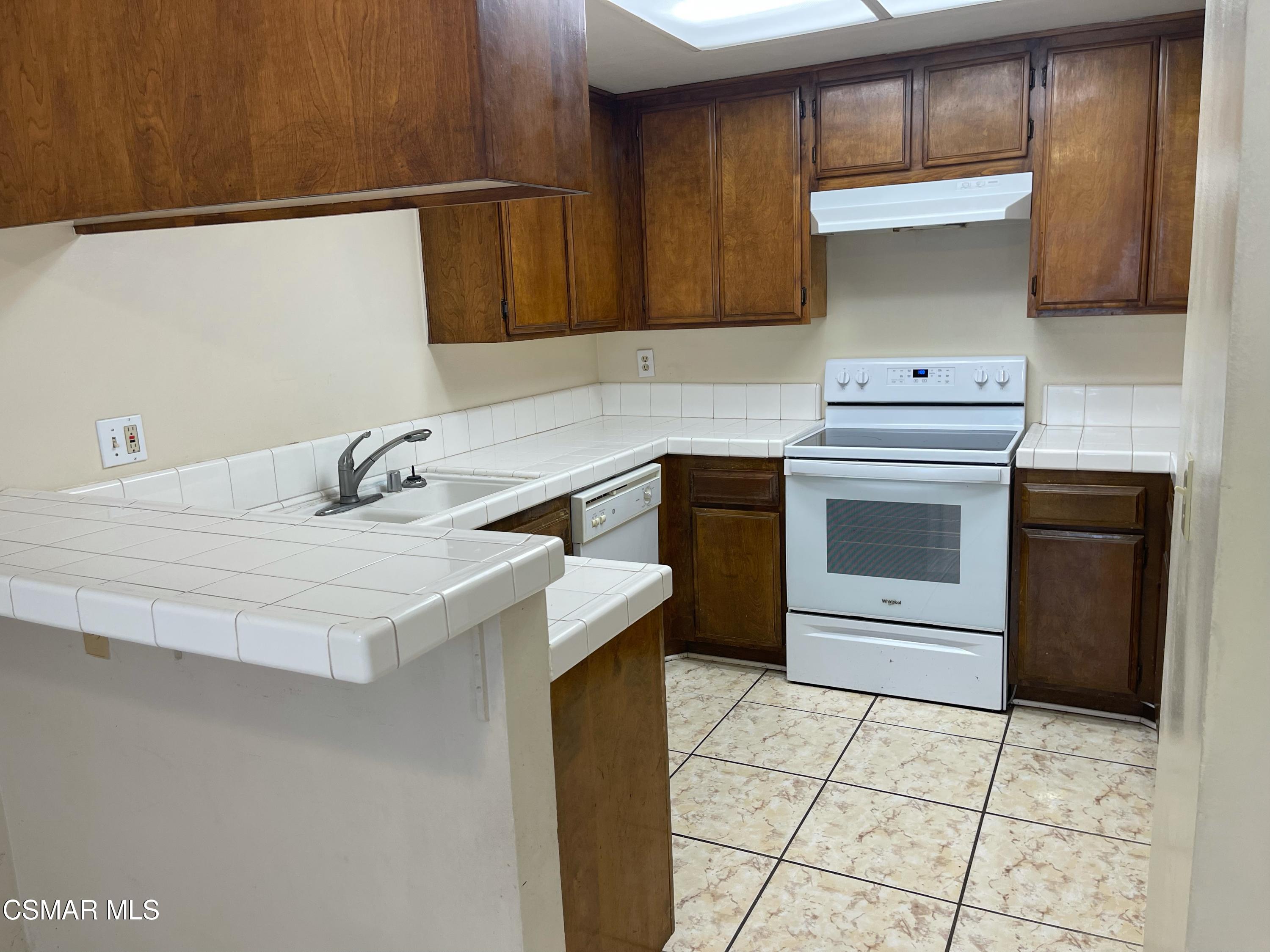 517 Spring Road, Unit 11 Moorpark, CA 93021 - Photo 2 of 4 a kitchen with a sink cabinets and appliances