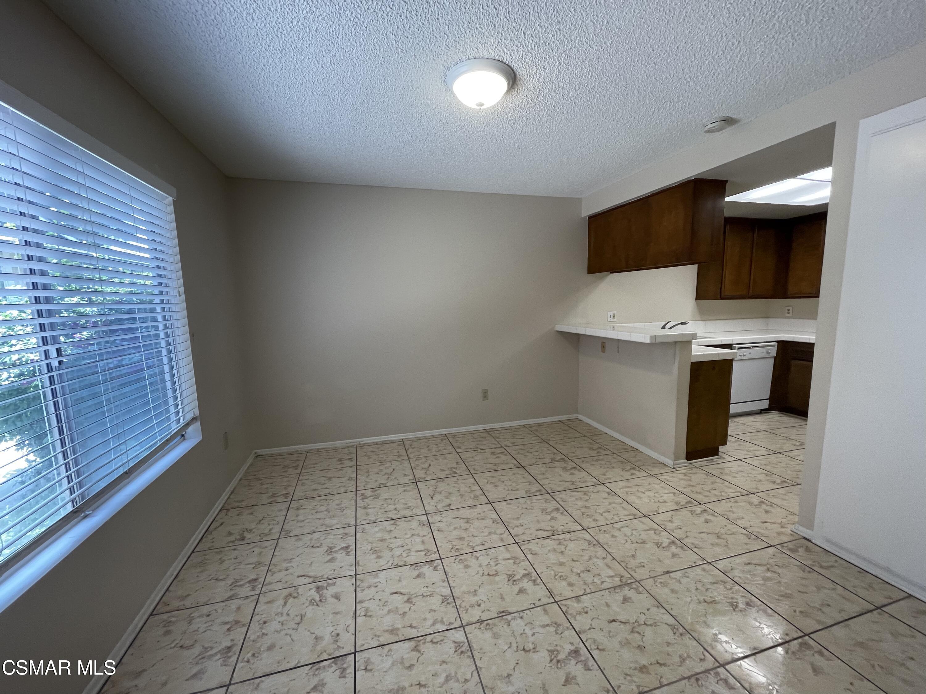 517 Spring Road, Unit 11 Moorpark, CA 93021 - Photo 3 of 4 a view of kitchen with microwave and cabinets
