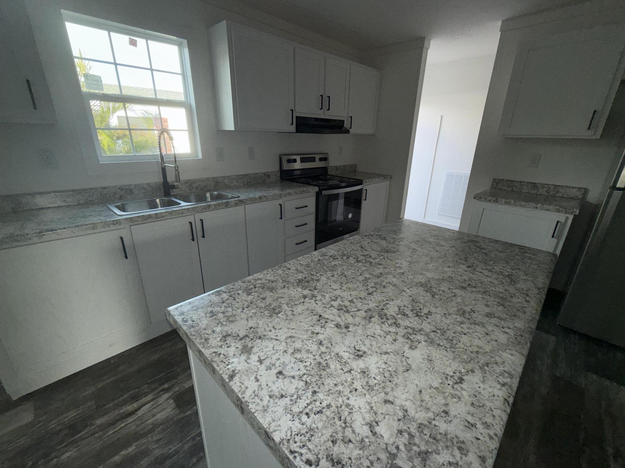 22963 Seaspray Place Boca Raton, FL 33428 - Photo 2 of 10 a kitchen with a sink stove and cabinets