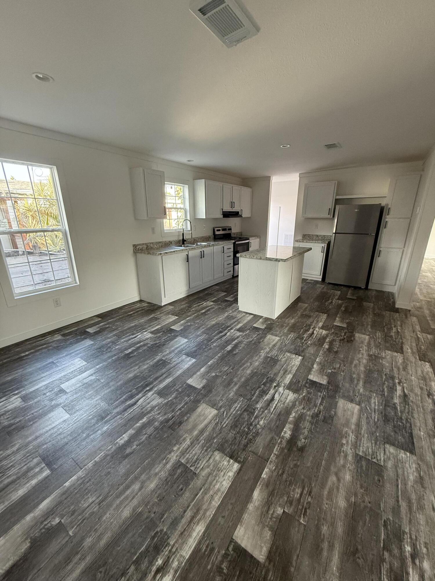 22963 Seaspray Place Boca Raton, FL 33428 - Photo 3 of 10 a view of a kitchen with a sink cabinets and a window
