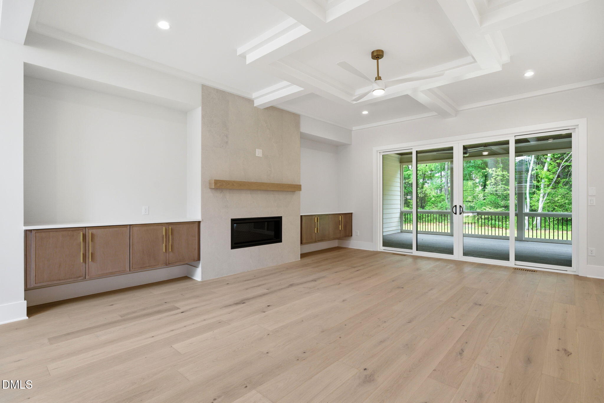1304 Sanctuary Pond Drive Raleigh, NC 27606 - Photo 14 of 52 a view of an empty room with a fireplace and a large window