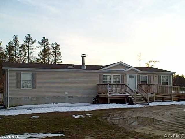 a view of a house with a wooden fence