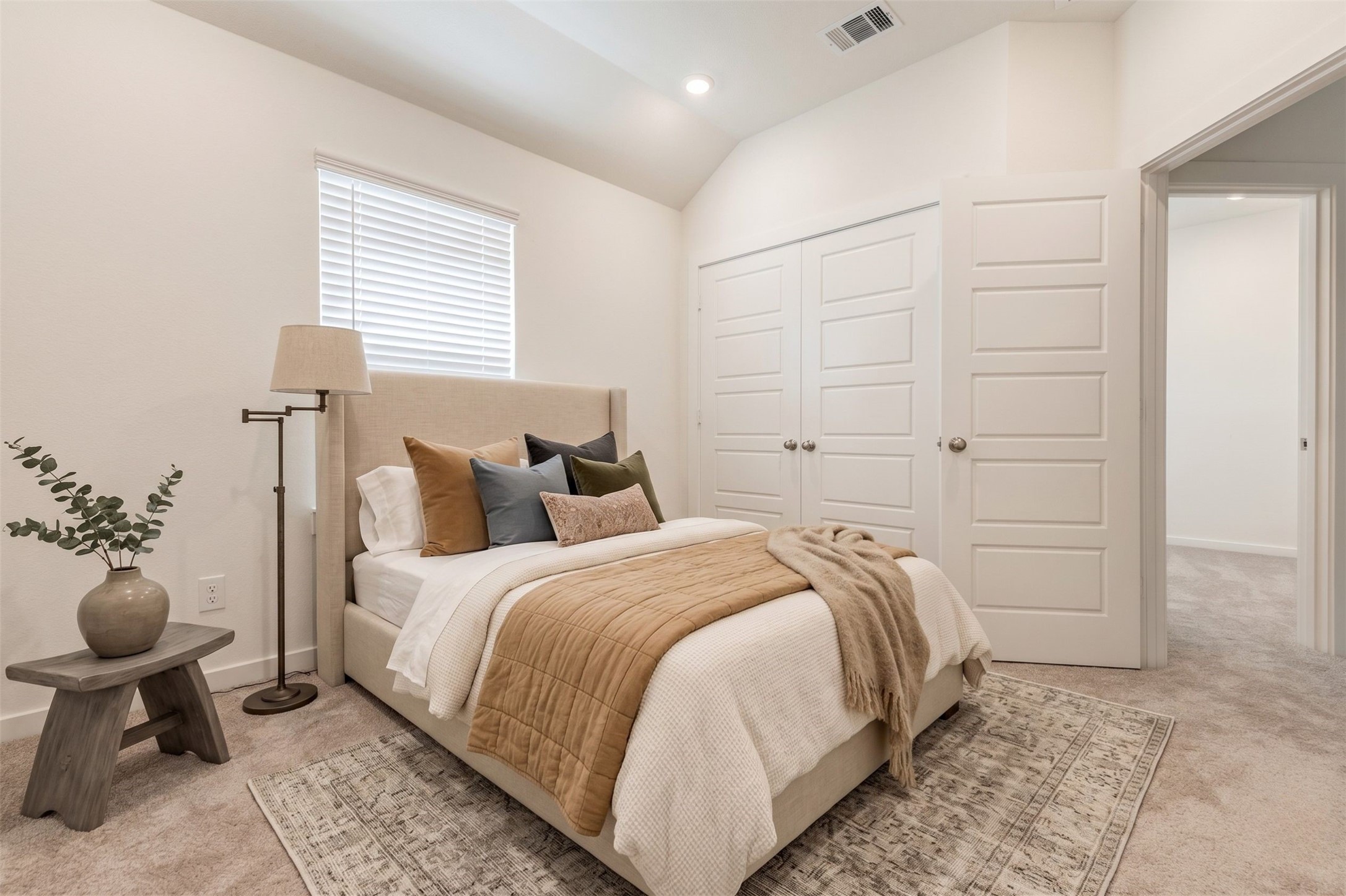 6475 Escondido Drive Rosharon, TX 77583 - Photo 7 of 32 This bedroom features a bright window with blinds, soft carpet, high ceilings, and a double-door closet for added storage. The neutral color palette and clean finishes create a fresh, welcoming space that can easily fit a variety of furniture layouts and personal styles. This photo has been virtually staged for visual reference.