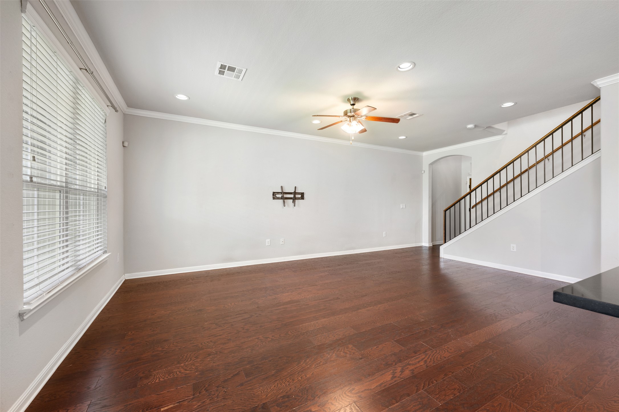 211 Parable Cove Pflugerville, TX 78660 - Photo 7 of 40 Expansive living area featuring rich wood-finish flooring, a ceiling fan with light fixture, recessed lighting, and crown molding