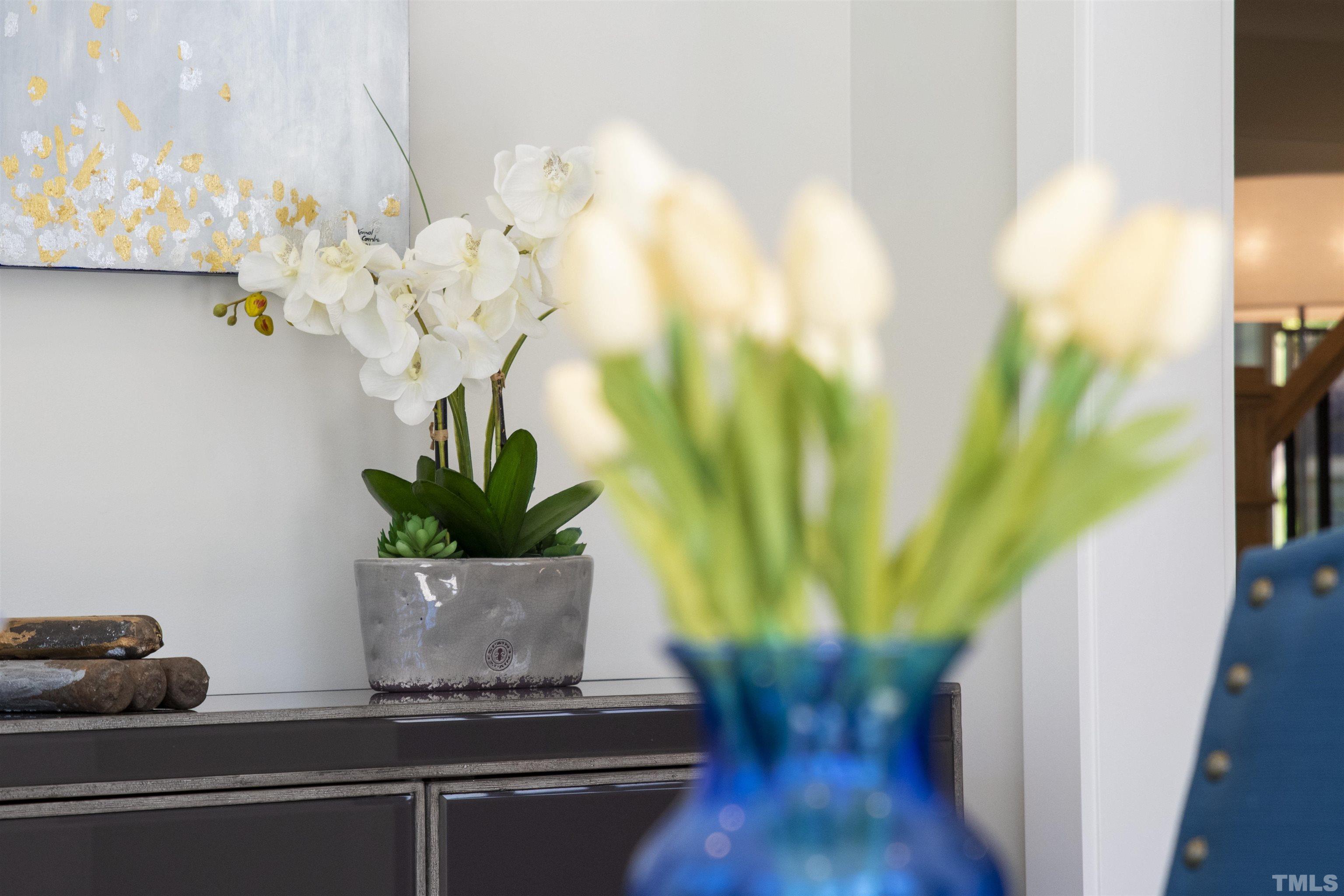 3512 Catalano Drive Raleigh, NC 27607 - Photo 13 of 64 a vase of flowers sitting on a table with chairs