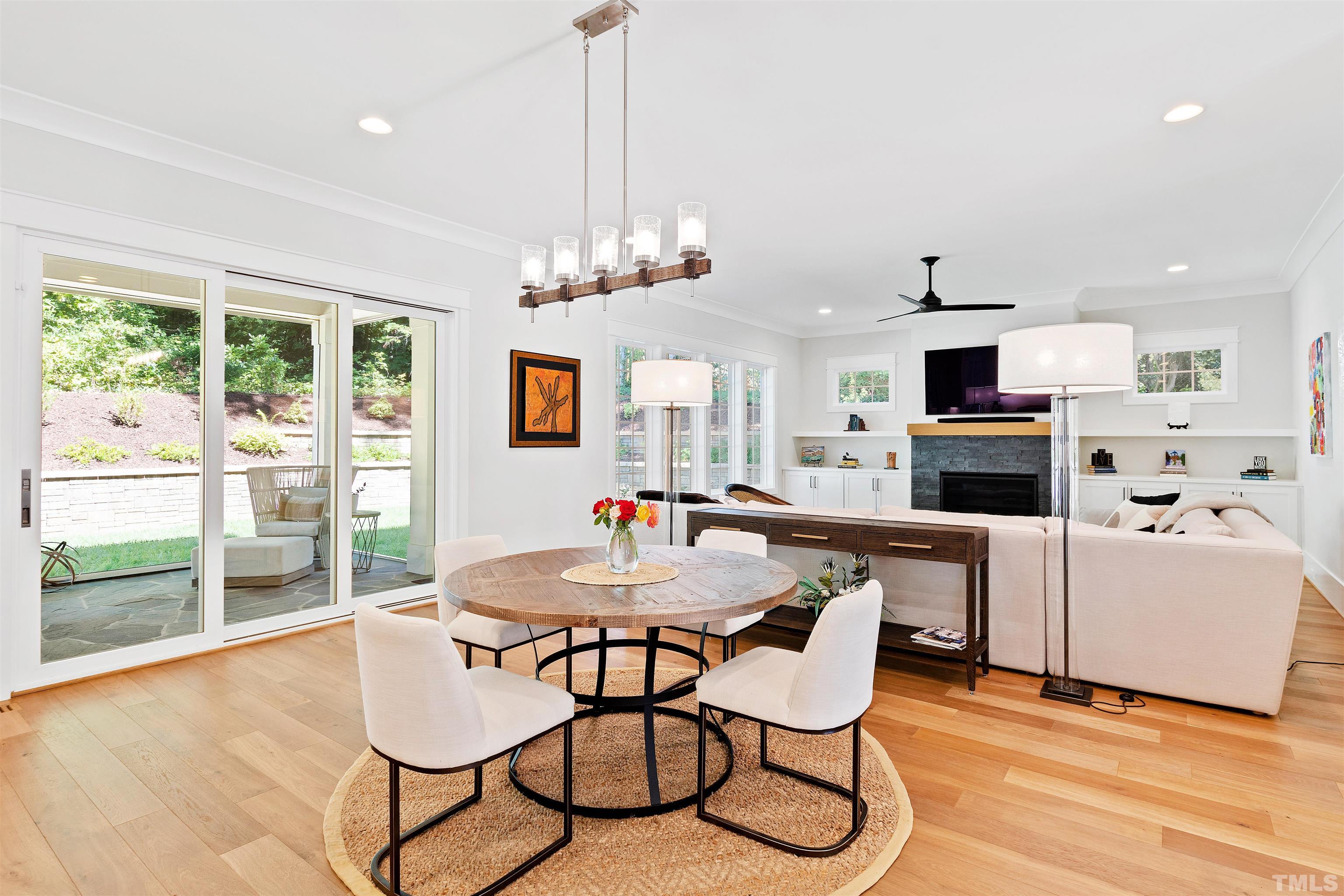 3512 Catalano Drive Raleigh, NC 27607 - Photo 18 of 64 a view of a dining room with furniture wooden floor and chandelier
