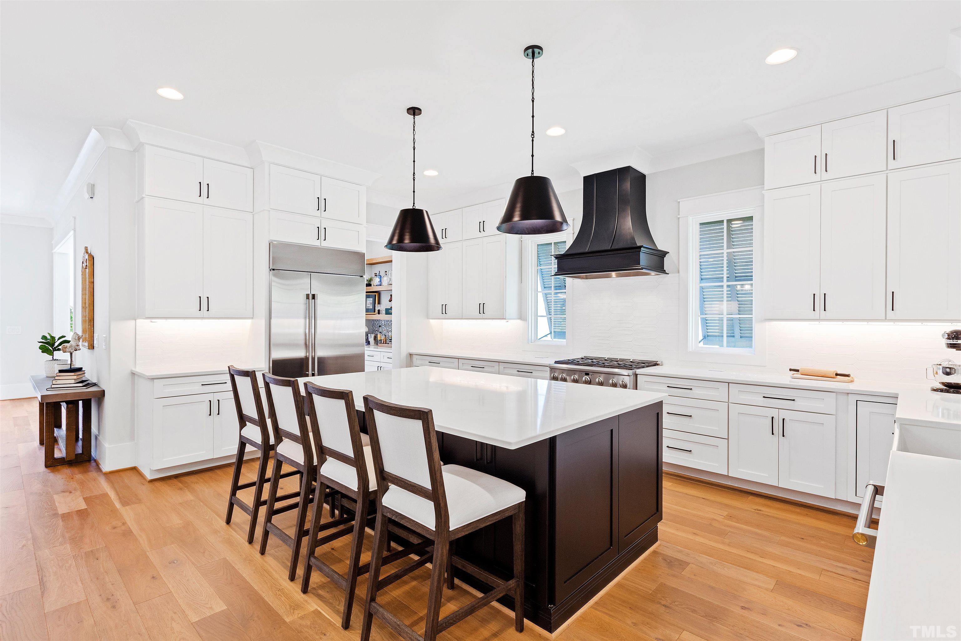 3512 Catalano Drive Raleigh, NC 27607 - Photo 2 of 64 a kitchen with a table chairs sink and cabinets