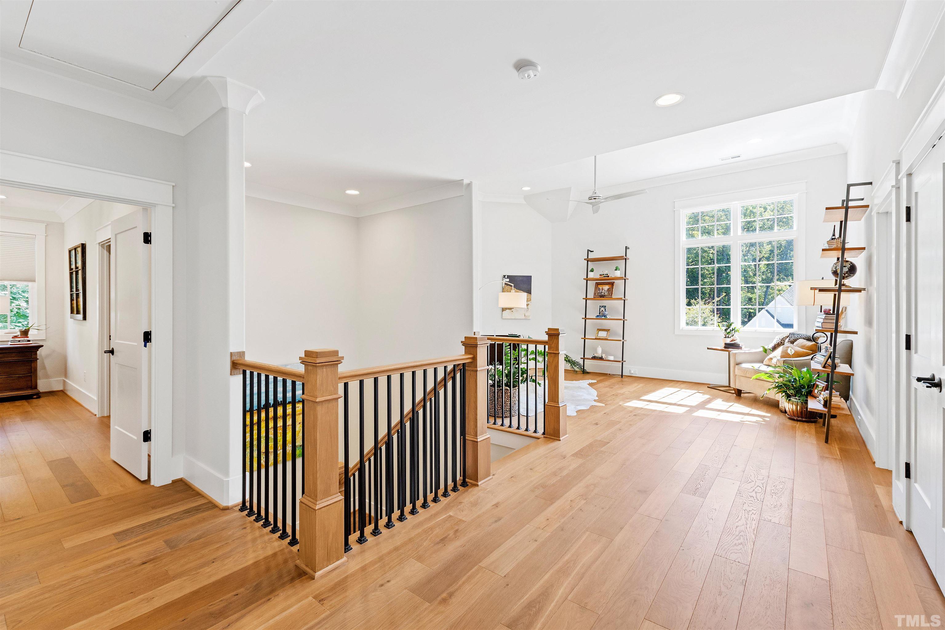 3512 Catalano Drive Raleigh, NC 27607 - Photo 33 of 64 a view of a hallway with wooden floor and windows