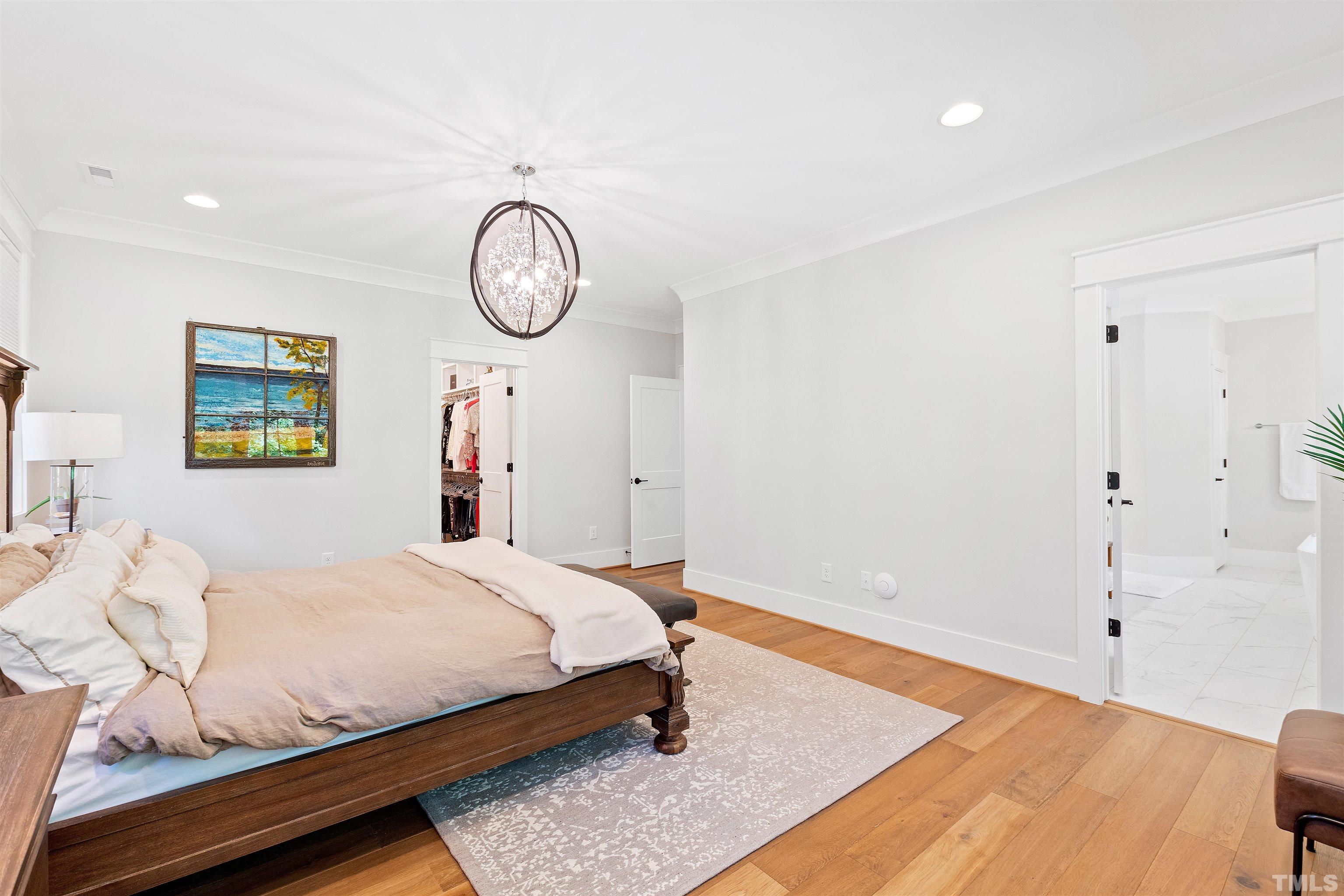 3512 Catalano Drive Raleigh, NC 27607 - Photo 36 of 64 a bedroom with a bed and a chandelier