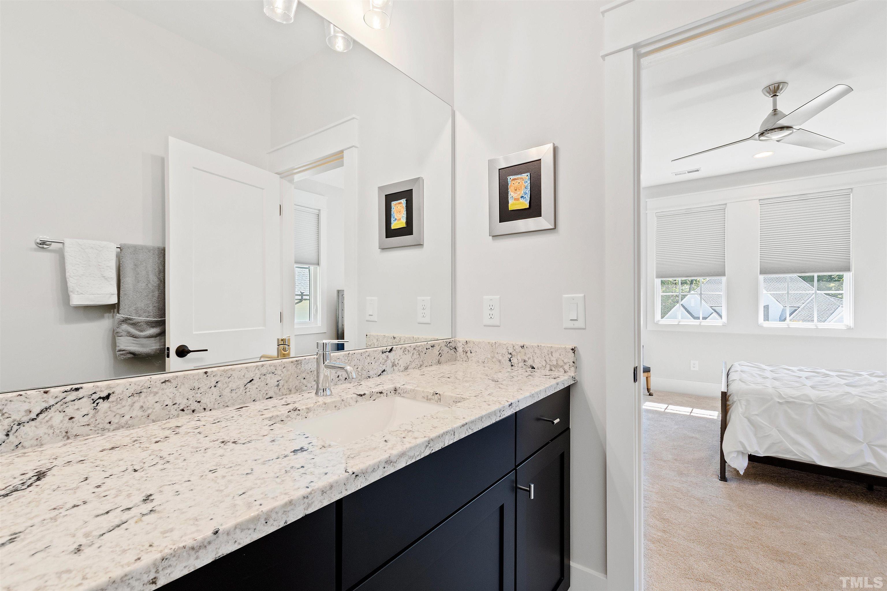 3512 Catalano Drive Raleigh, NC 27607 - Photo 47 of 64 a en suite bathroom with a granite countertop sink and a mirror