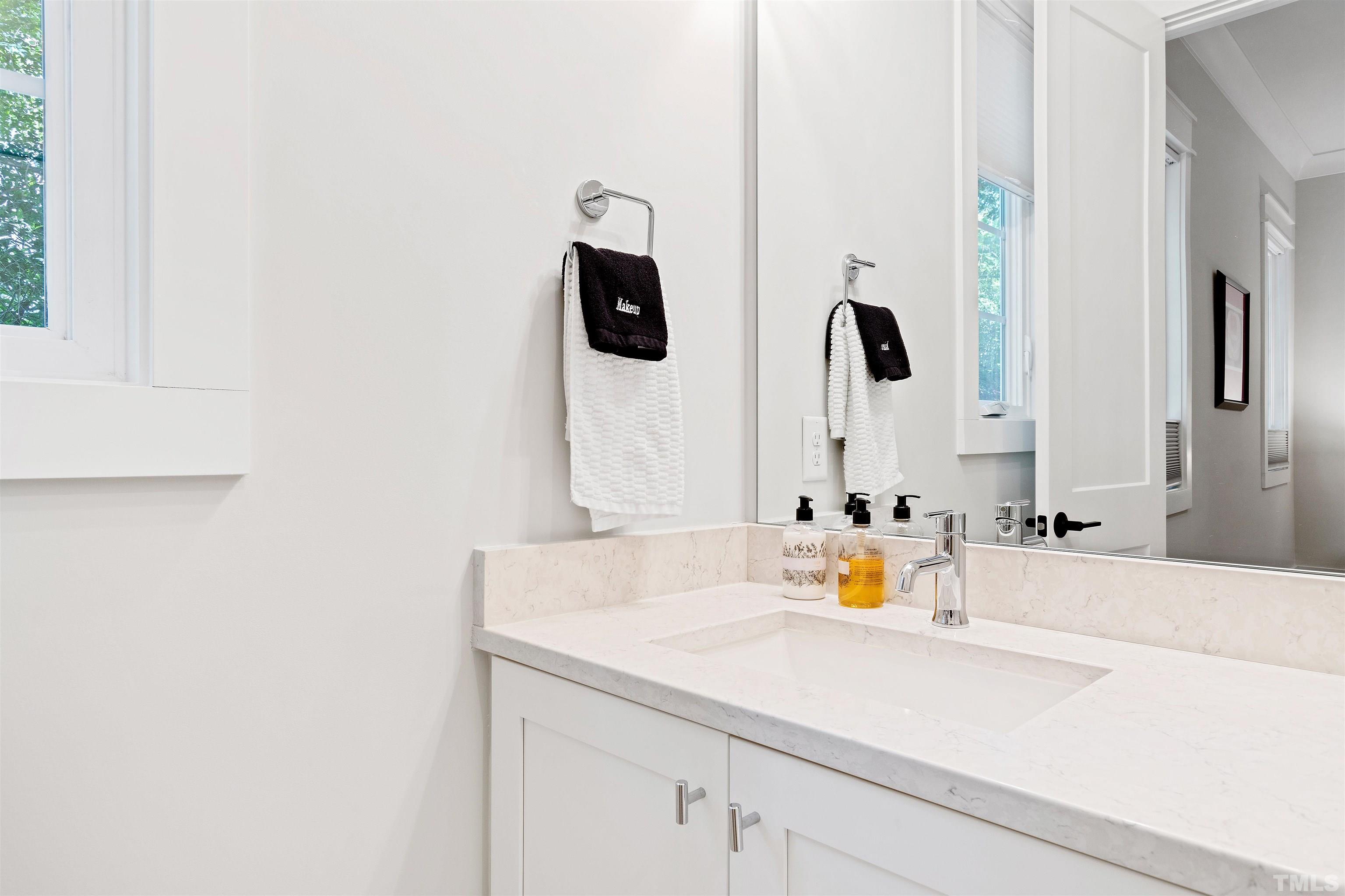 3512 Catalano Drive Raleigh, NC 27607 - Photo 51 of 64 a bathroom with a sink and a mirror