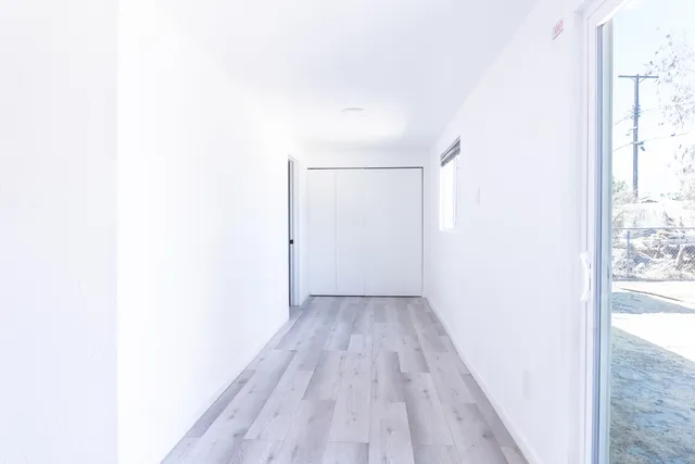 a view of a room with wooden floor