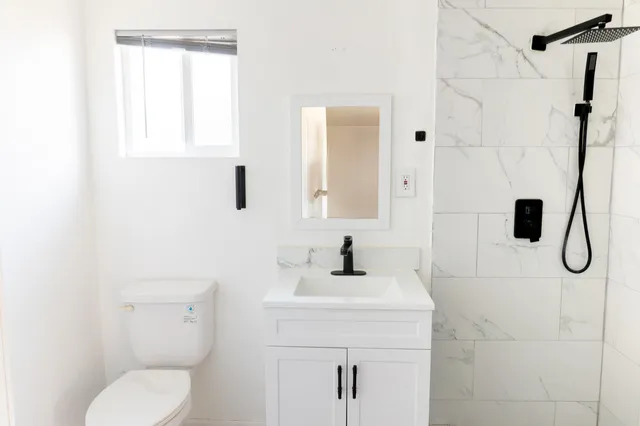 a bathroom with a sink toilet and shower