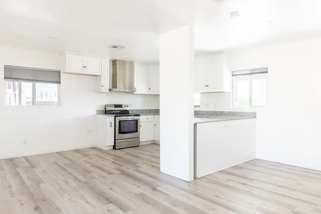 a kitchen with granite countertop a refrigerator and a stove