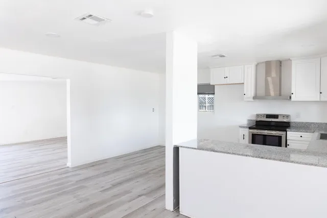 a kitchen with granite countertop a stove and a refrigerator