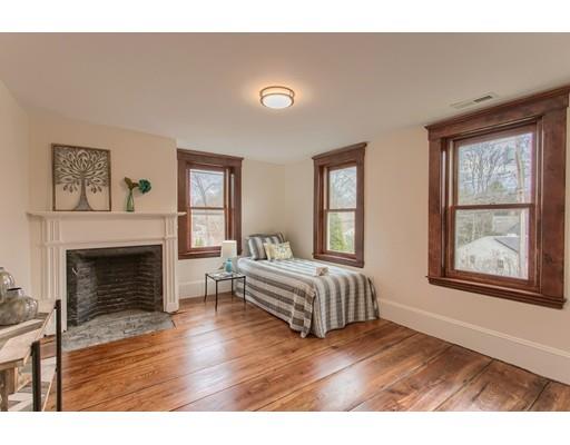 446 Liberty Square Road Boxborough, MA 01719 - Photo 13 of 29 a living room with a fireplace furniture a flat screen tv and wooden floor