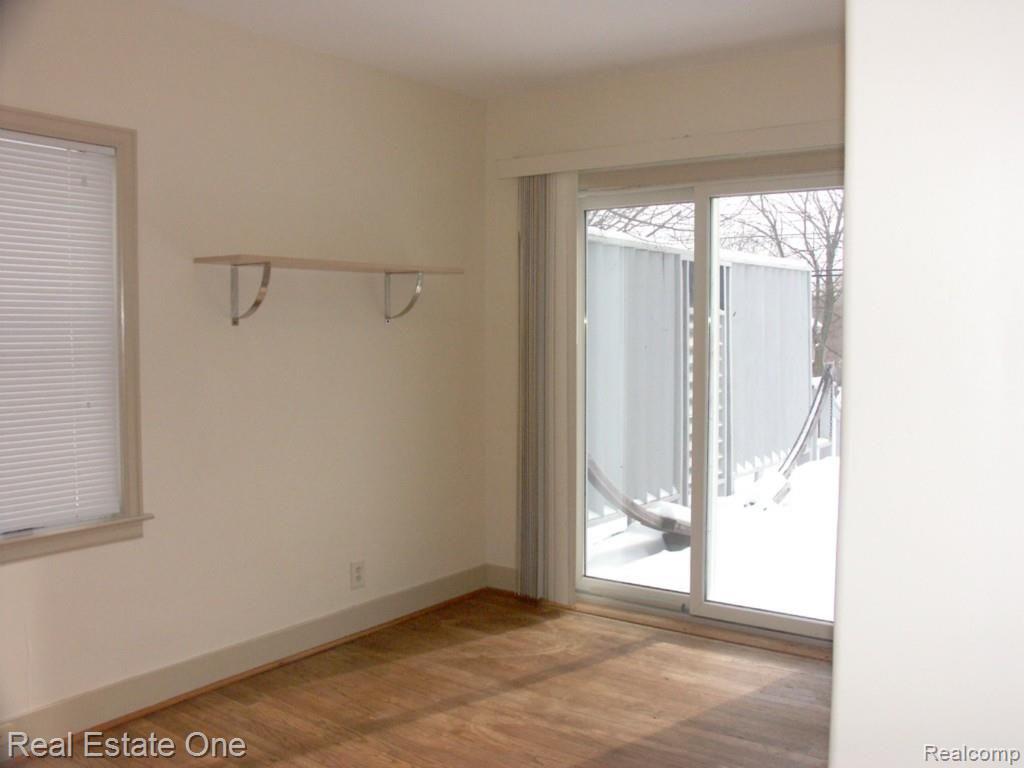 6233 Waldon Road Clarkston, MI 48346 - Photo 24 of 41 bedroom 2 mainfloor, hardwood and sliding door to deck