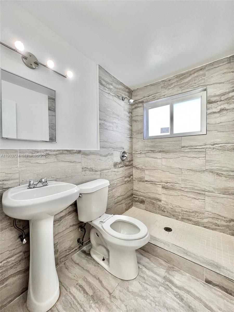 10 Northwest 77th Street, Unit 10 Miami, FL 33150 - Photo 6 of 12 a bathroom with a sink toilet and shower