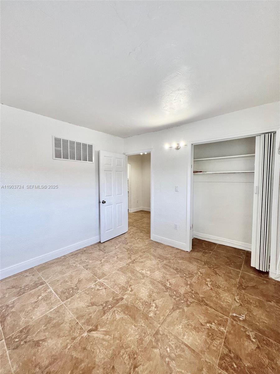 10 Northwest 77th Street, Unit 10 Miami, FL 33150 - Photo 9 of 12 an empty room with a natural light