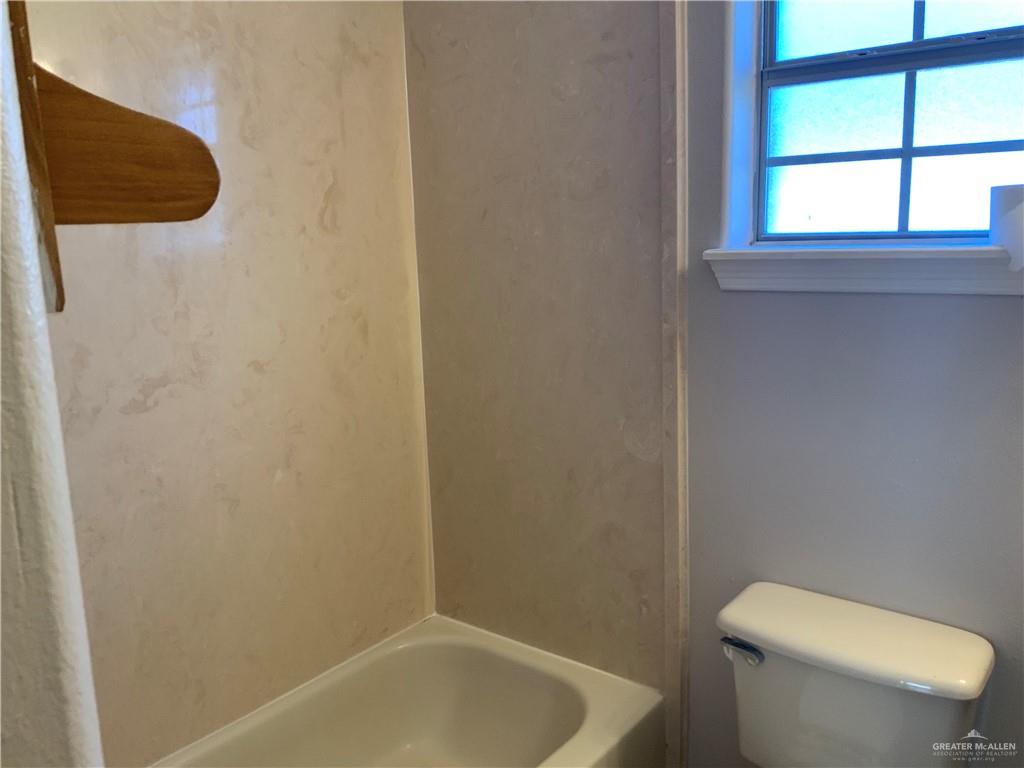 808 West Bronze Avenue, Unit B Pharr, TX 78577 - Photo 16 of 20 a white toilet sitting next to a window