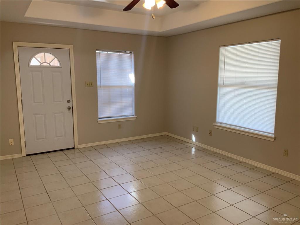 808 West Bronze Avenue, Unit B Pharr, TX 78577 - Photo 19 of 20 an empty room with chandelier fan and window