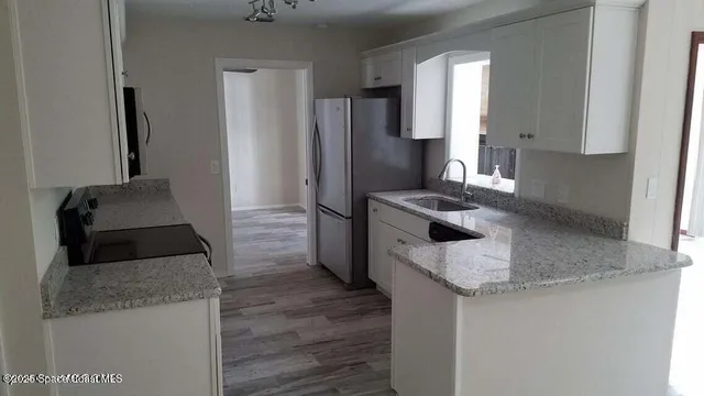 wooden floor that has windows in a room