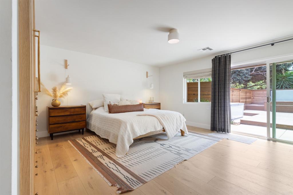710 Edelweiss Lane Encinitas, CA 92024 - Photo 17 of 32 a bedroom with a bed and large windows