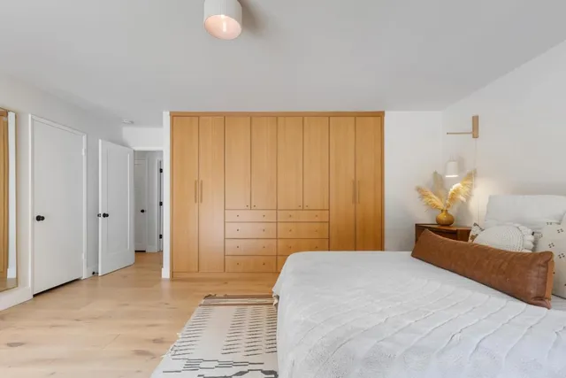 a bedroom with a bed and a chandelier