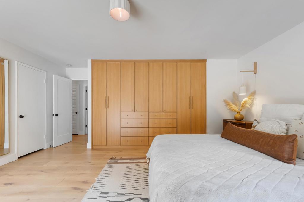 710 Edelweiss Lane Encinitas, CA 92024 - Photo 18 of 32 a bedroom with a bed and a chandelier