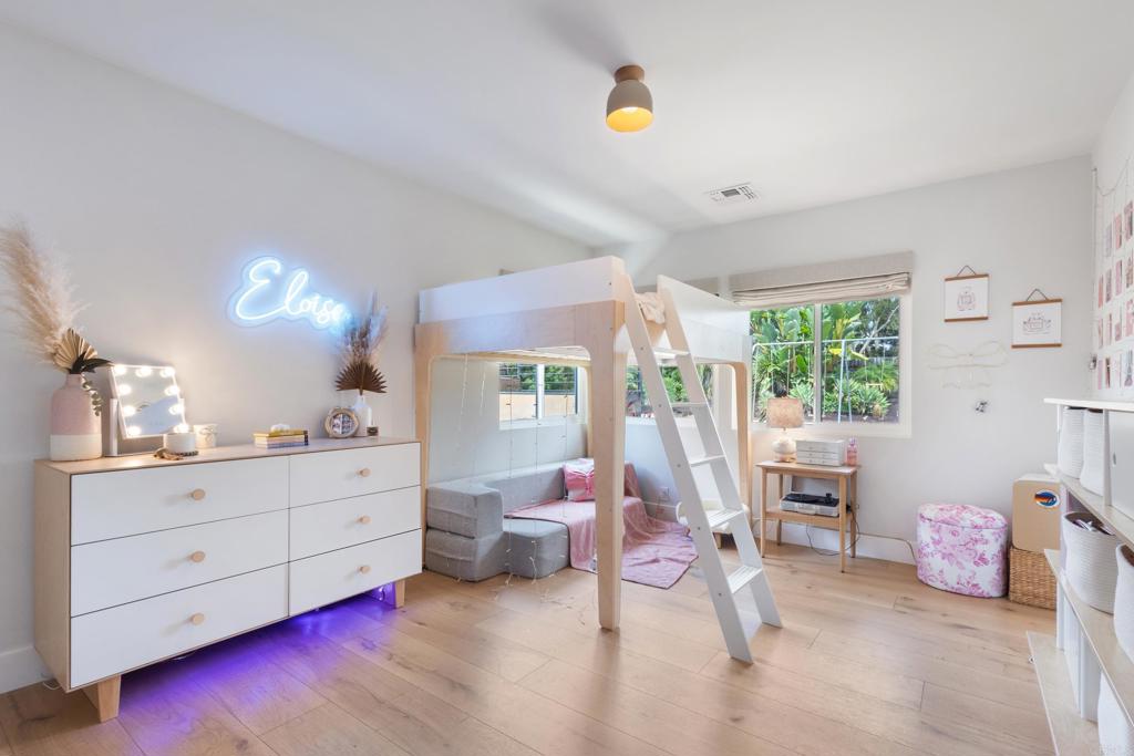 710 Edelweiss Lane Encinitas, CA 92024 - Photo 21 of 32 a bedroom with furniture and a large window