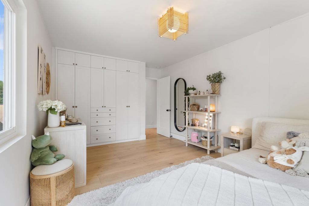 710 Edelweiss Lane Encinitas, CA 92024 - Photo 23 of 32 a bedroom with a bed and a chandelier