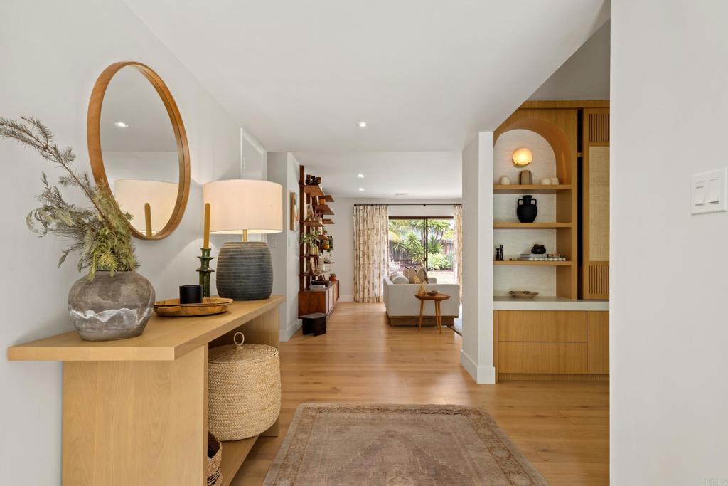 710 Edelweiss Lane Encinitas, CA 92024 - Photo 5 of 32 a very nice looking room with a large window and chandelier