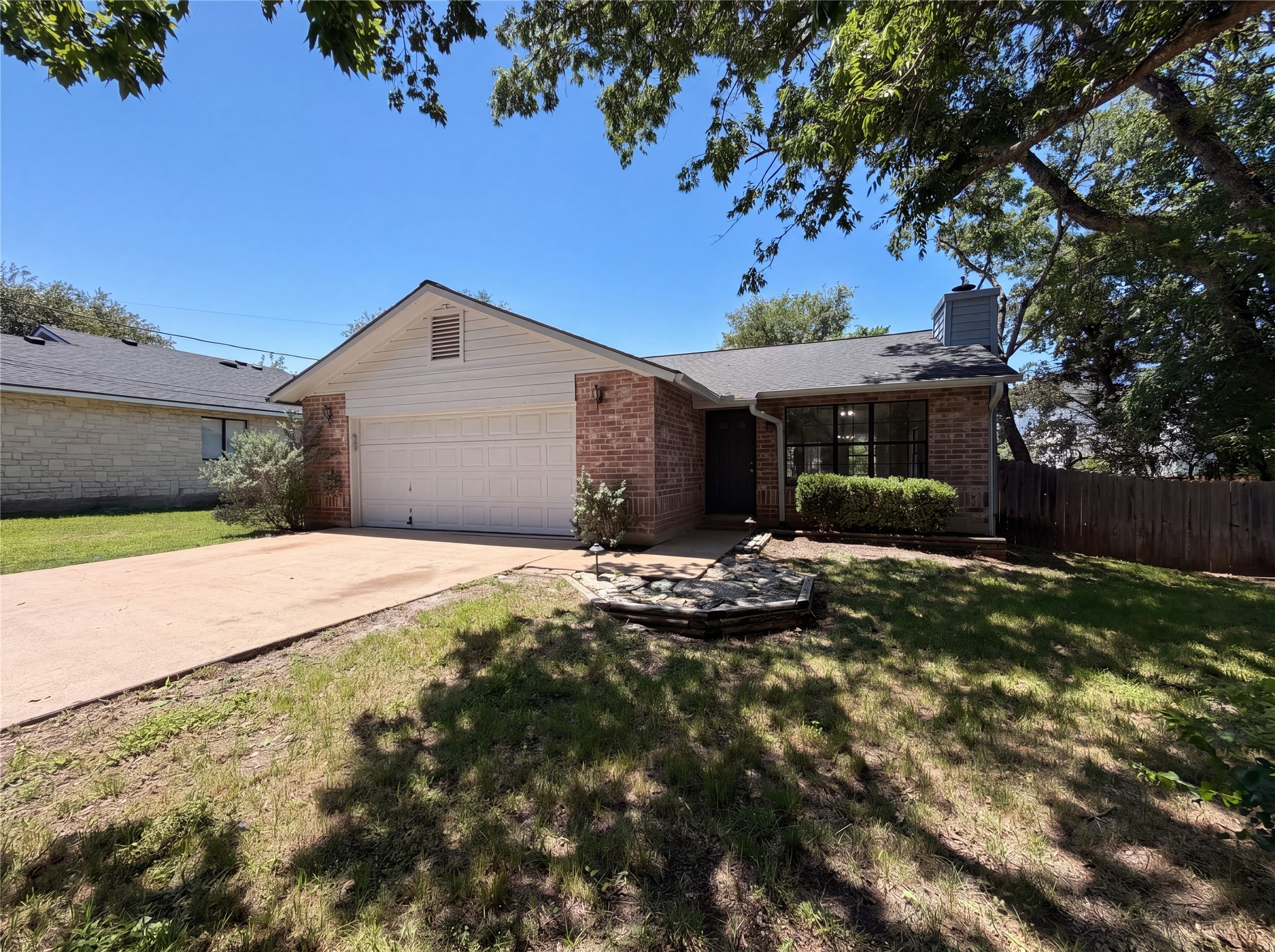 1111 North Riviera Circle Cedar Park, TX 78613 - Photo 1 of 17 Brick exterior with a white garage door