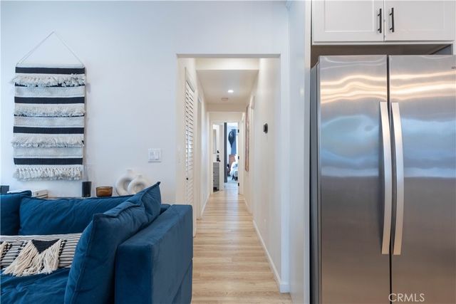 a walk in closet and view of living room