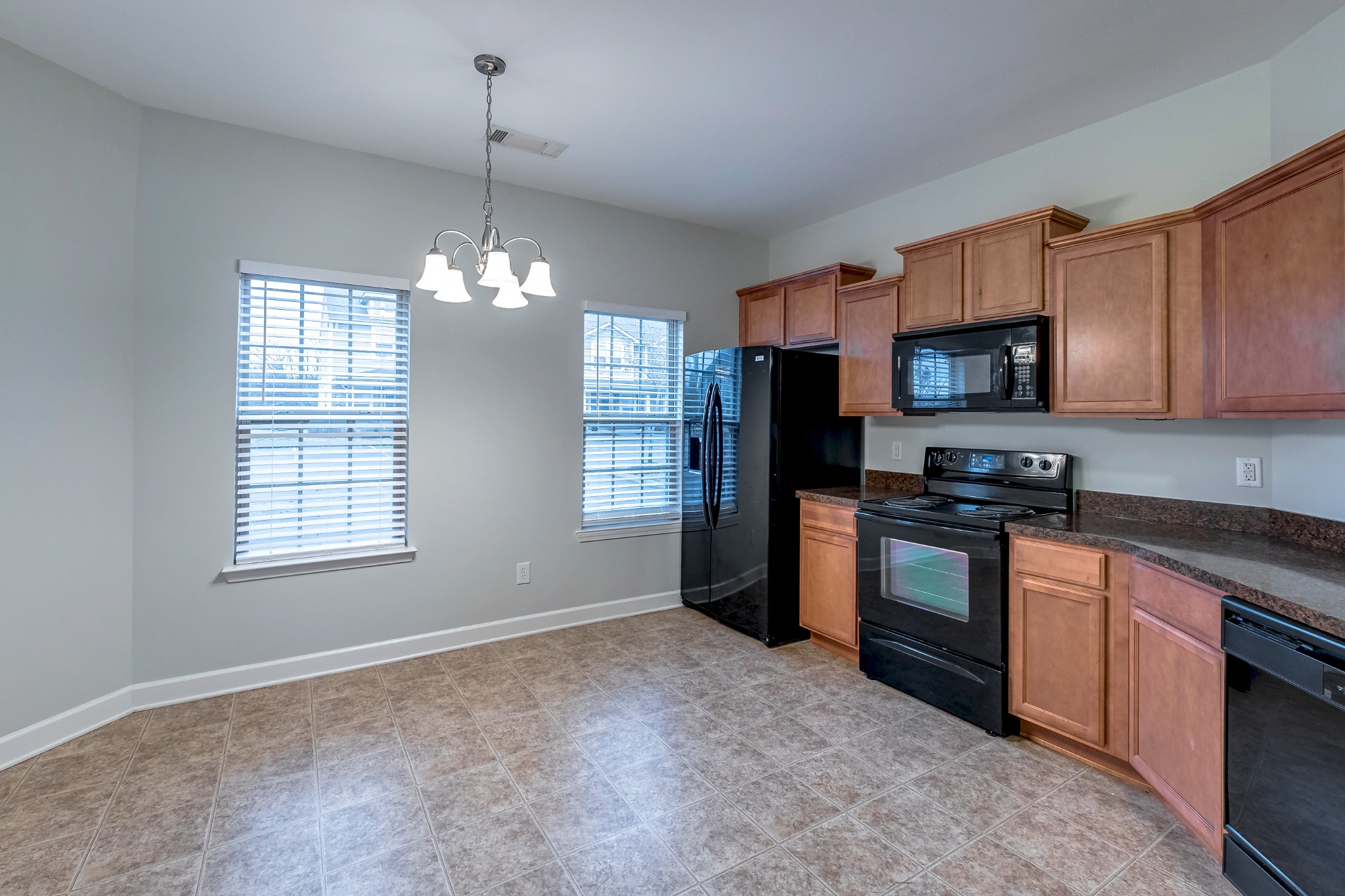 5441 Perlou Lane Murfreesboro, TN 37128 - Photo 12 of 35 a kitchen with stainless steel appliances granite countertop a stove sink microwave and refrigerator