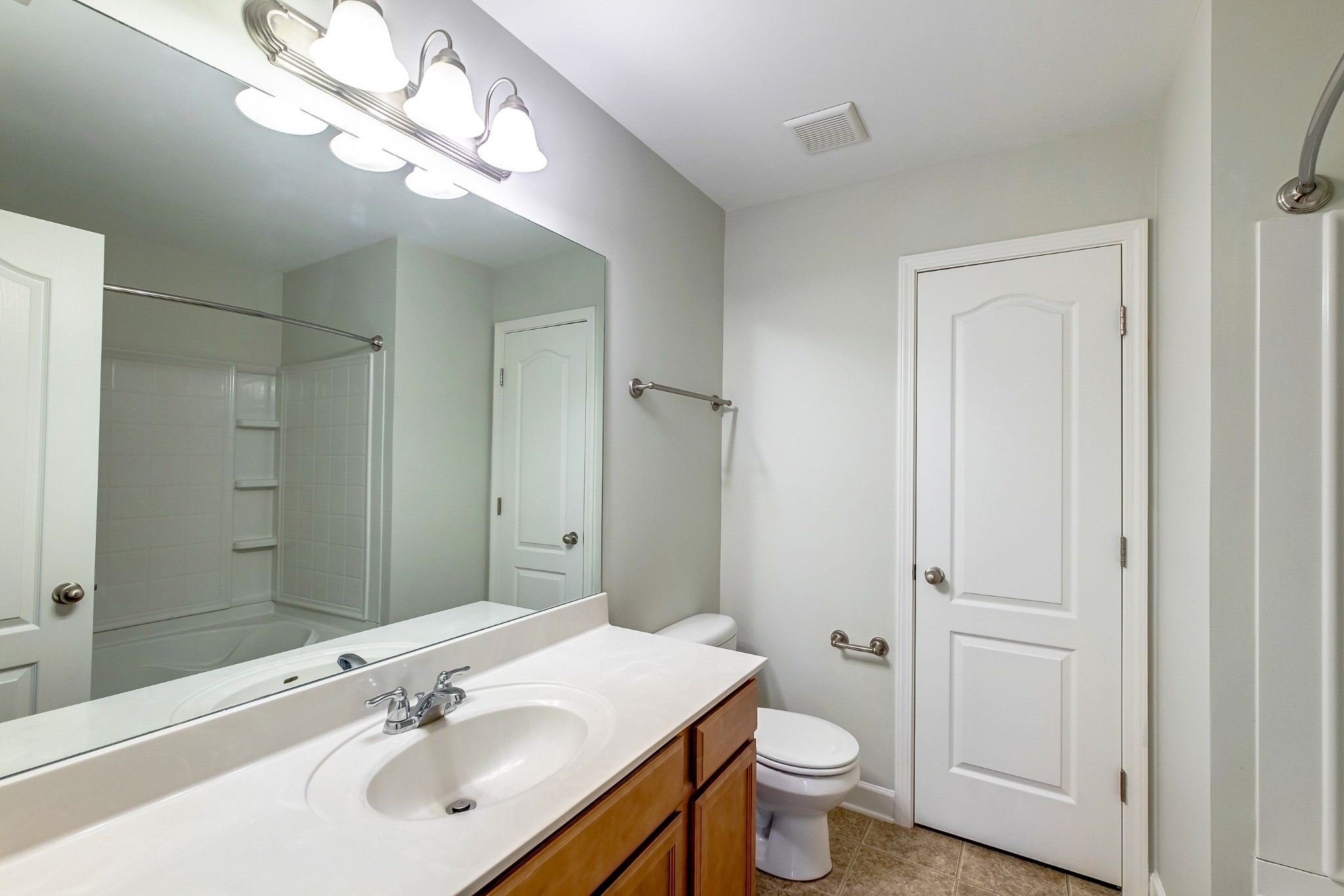 5441 Perlou Lane Murfreesboro, TN 37128 - Photo 22 of 35 a bathroom with a toilet sink and mirror